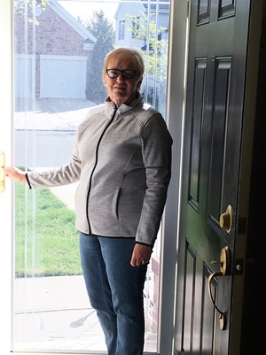 Barbara spine patient standing by door